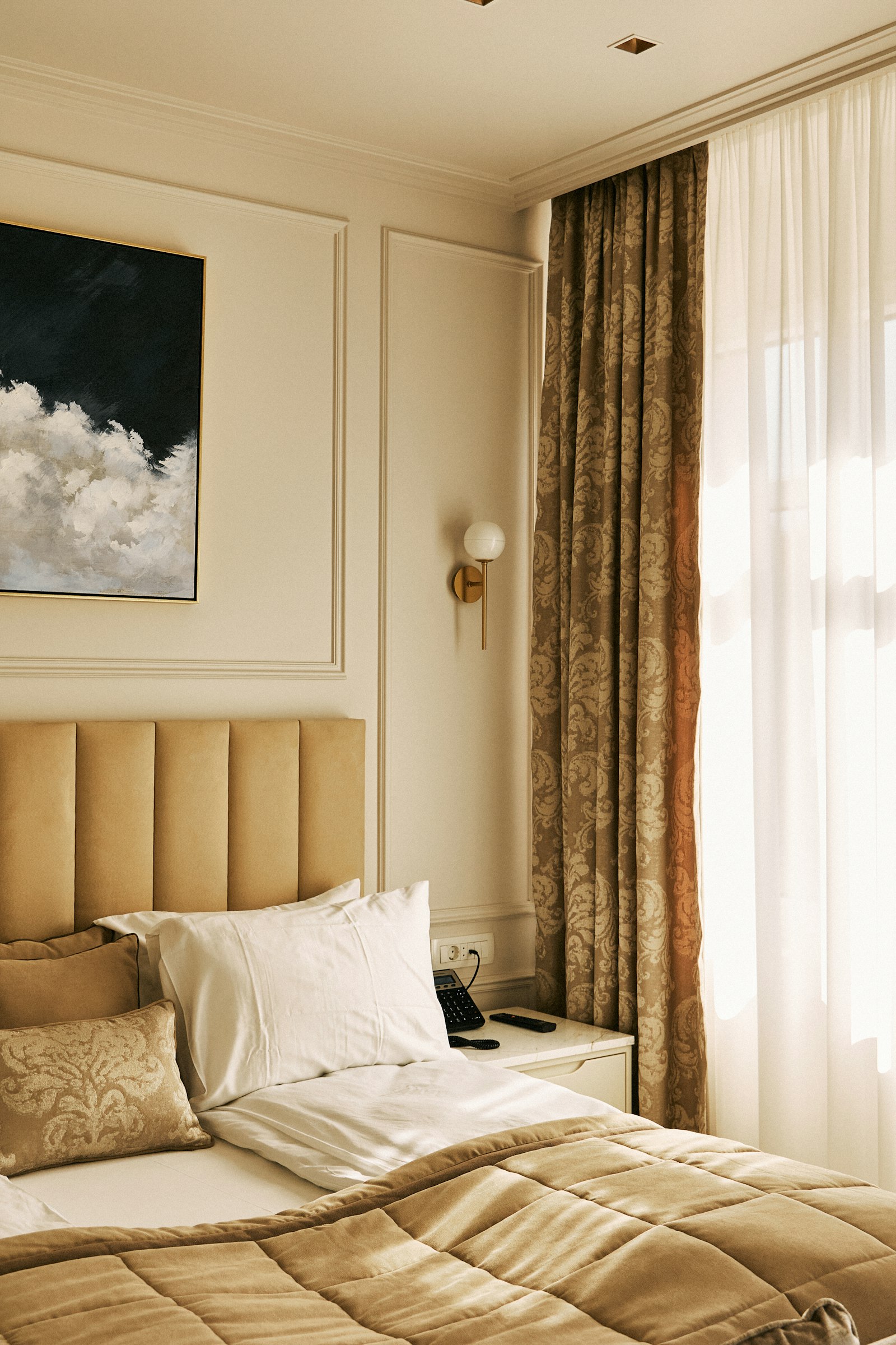 Bedroom with a large bed and statement art piece on the wall
